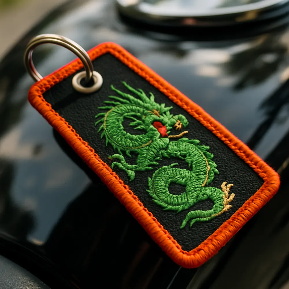 Embroidered motorcycle key tag resting on a fuel tank